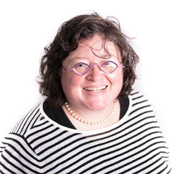 A woman smiles in a formal headshot with a white background.