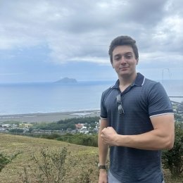 David Hamilton with the Taiwanese countryside behind him.