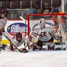 The Norwich Women’s Ice Hockey team on the ice in uniform playing against Salem State