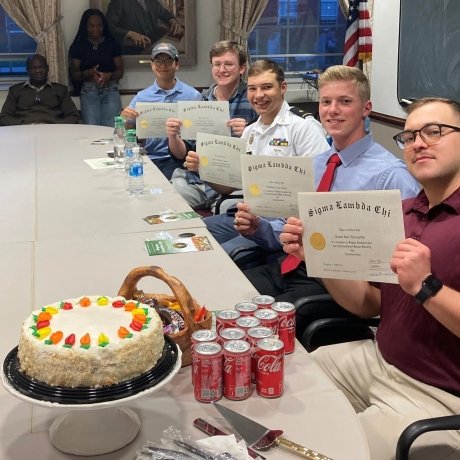 Five students holding their certificates of Induction to the School of Engineering Sigma Lambda Chi