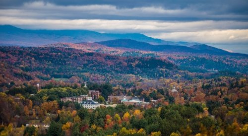 Aerial photo of Norwich University campus surrounded by mountains.