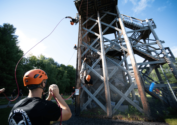 Students rappelling from the rappel tower. 