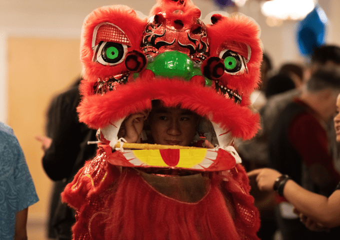 Image of student in Chinese Lion Dance dragon costume.