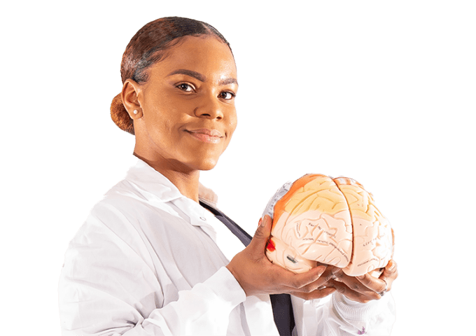 Shawnae T. Evans '21, holding brain in lab coat. 