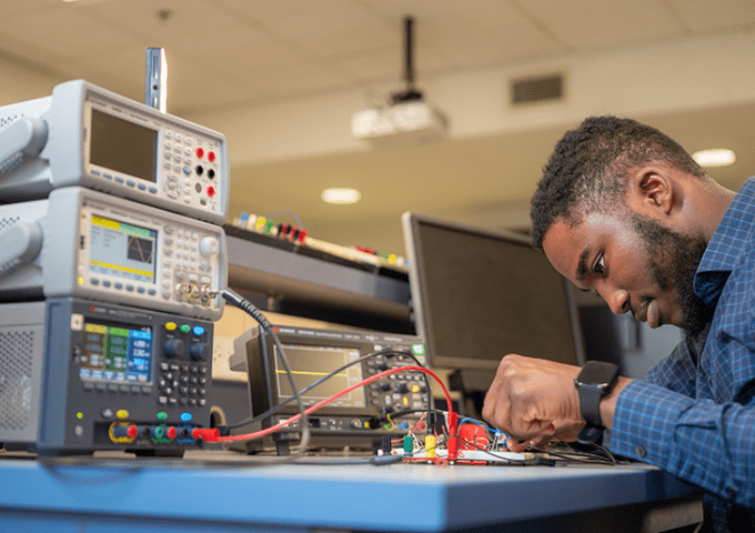 Student studying science equipment.