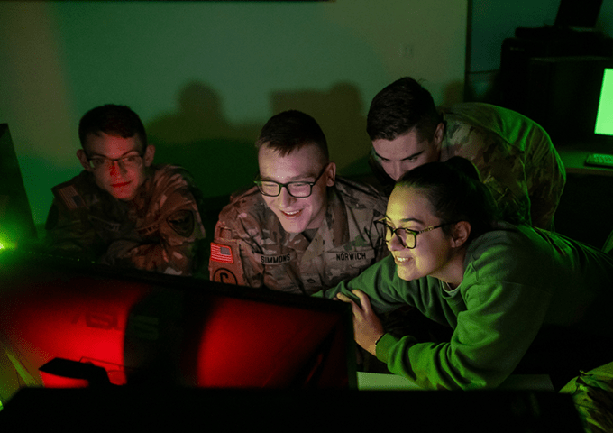 Students working together around a computer in the warroom.